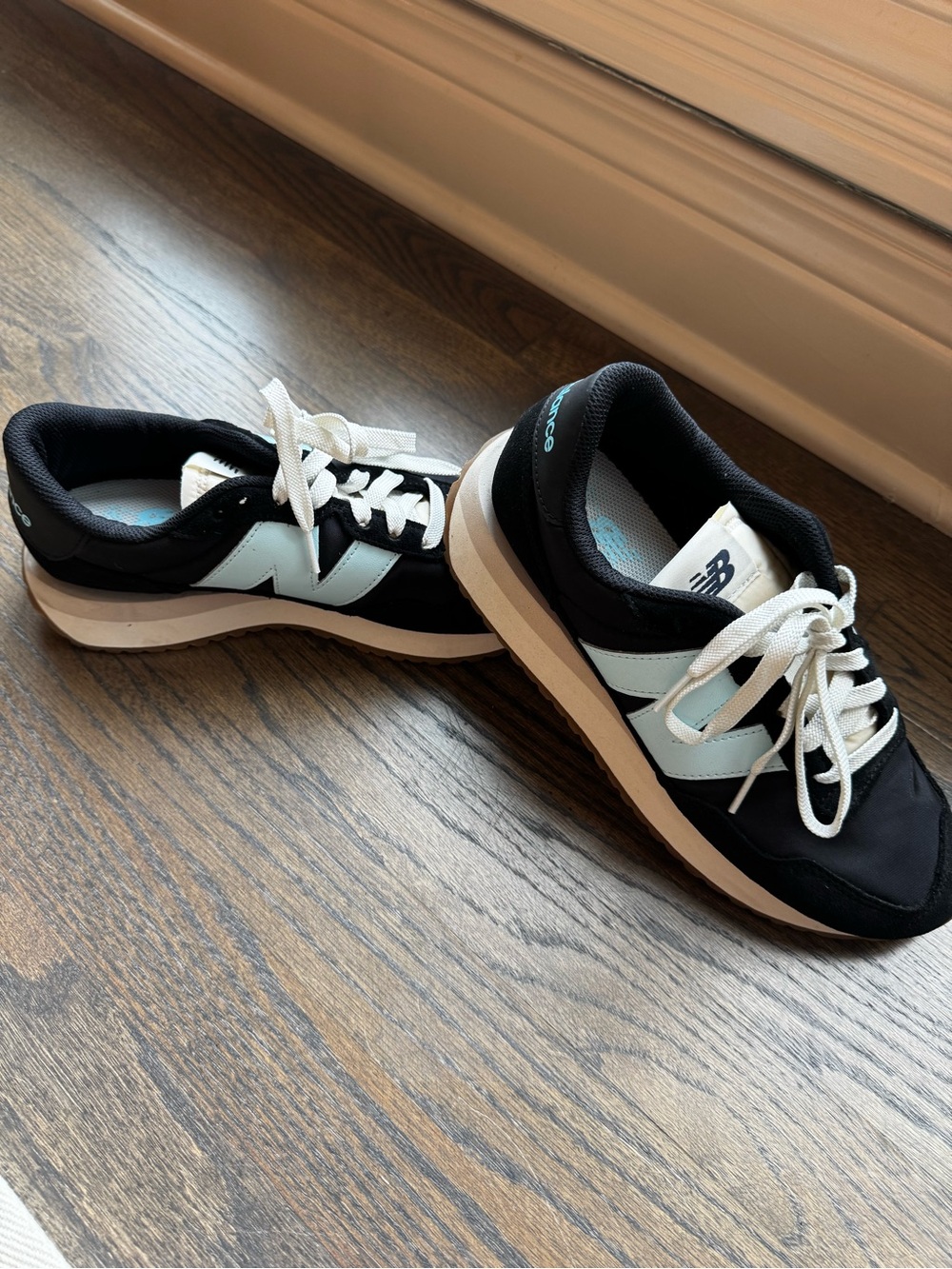 New Balance Women's Black Sneakers with Pale Blue Accents and White Laces